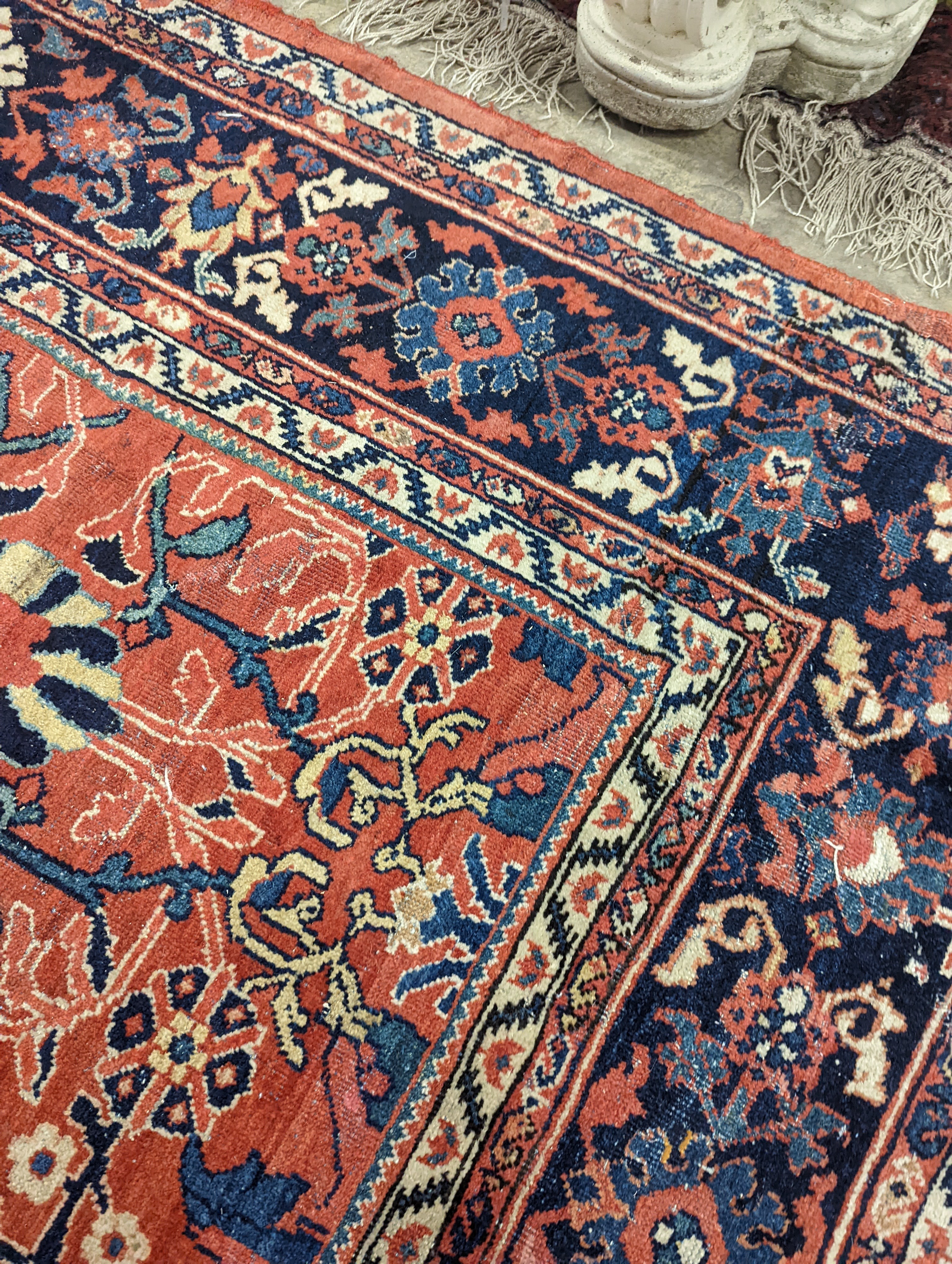 A Heriz brick red ground carpet, 364 x 280cm